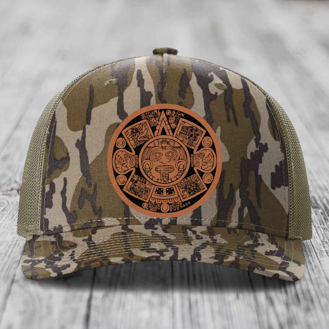Camouflage trucker hat with Aztec calendar leather patch on front.