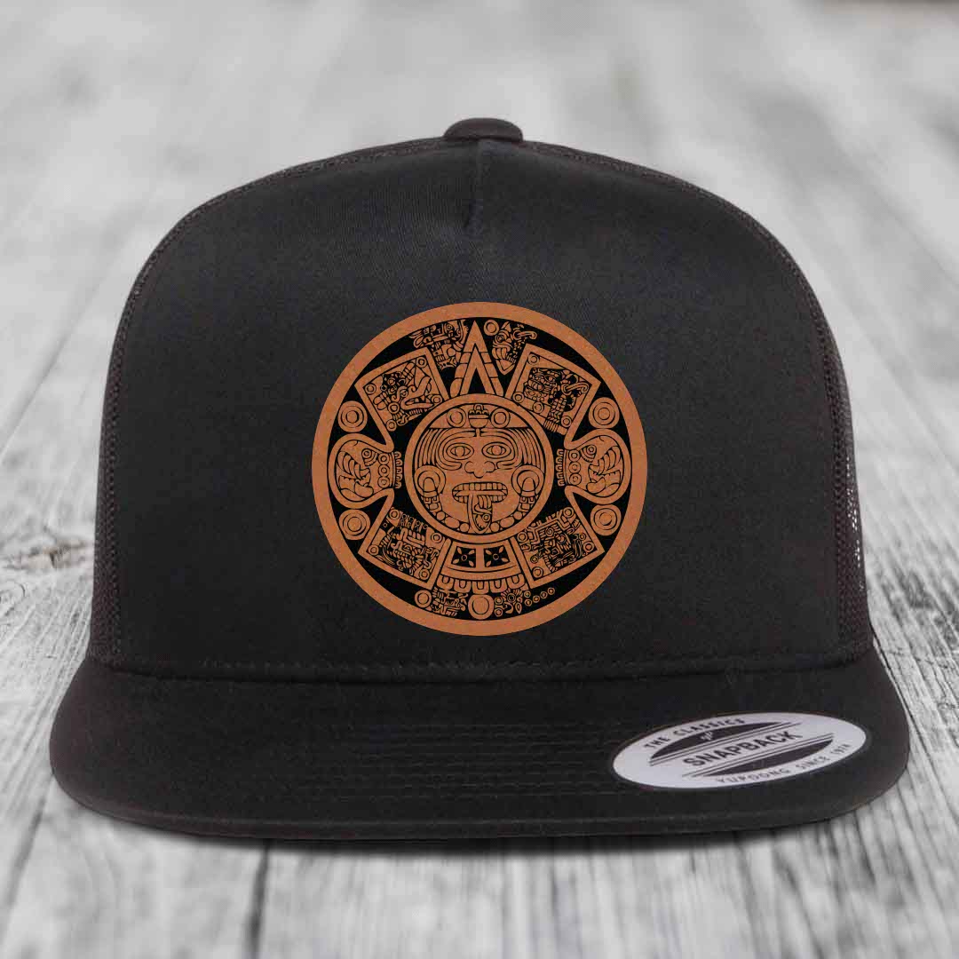 Black snapback hat with brown Aztec calendar leather patch on front.