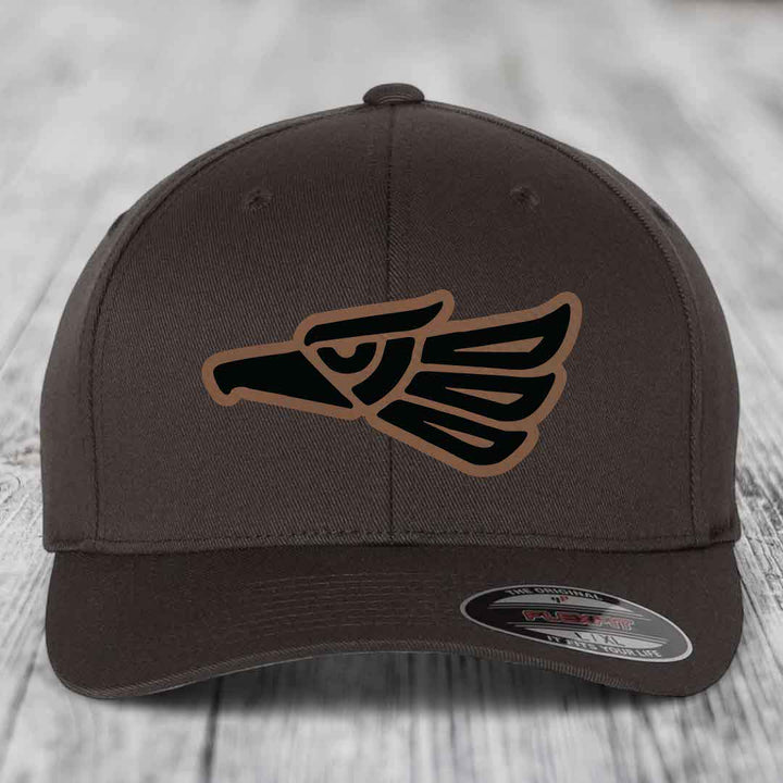 Dark brown Flexfit hat with Aztec-style eagle patch in black and tan.