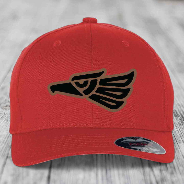 Red baseball cap with black and tan Aztec eagle patch on front.