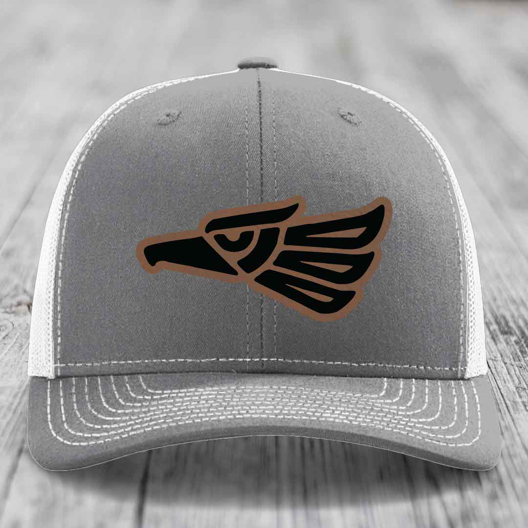 Grey trucker hat with black and brown Aztec eagle patch on front.