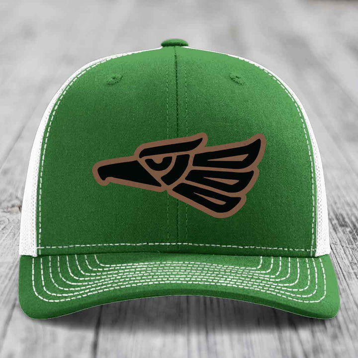 Green trucker hat with white mesh back and embroidered eagle patch in black and brown.