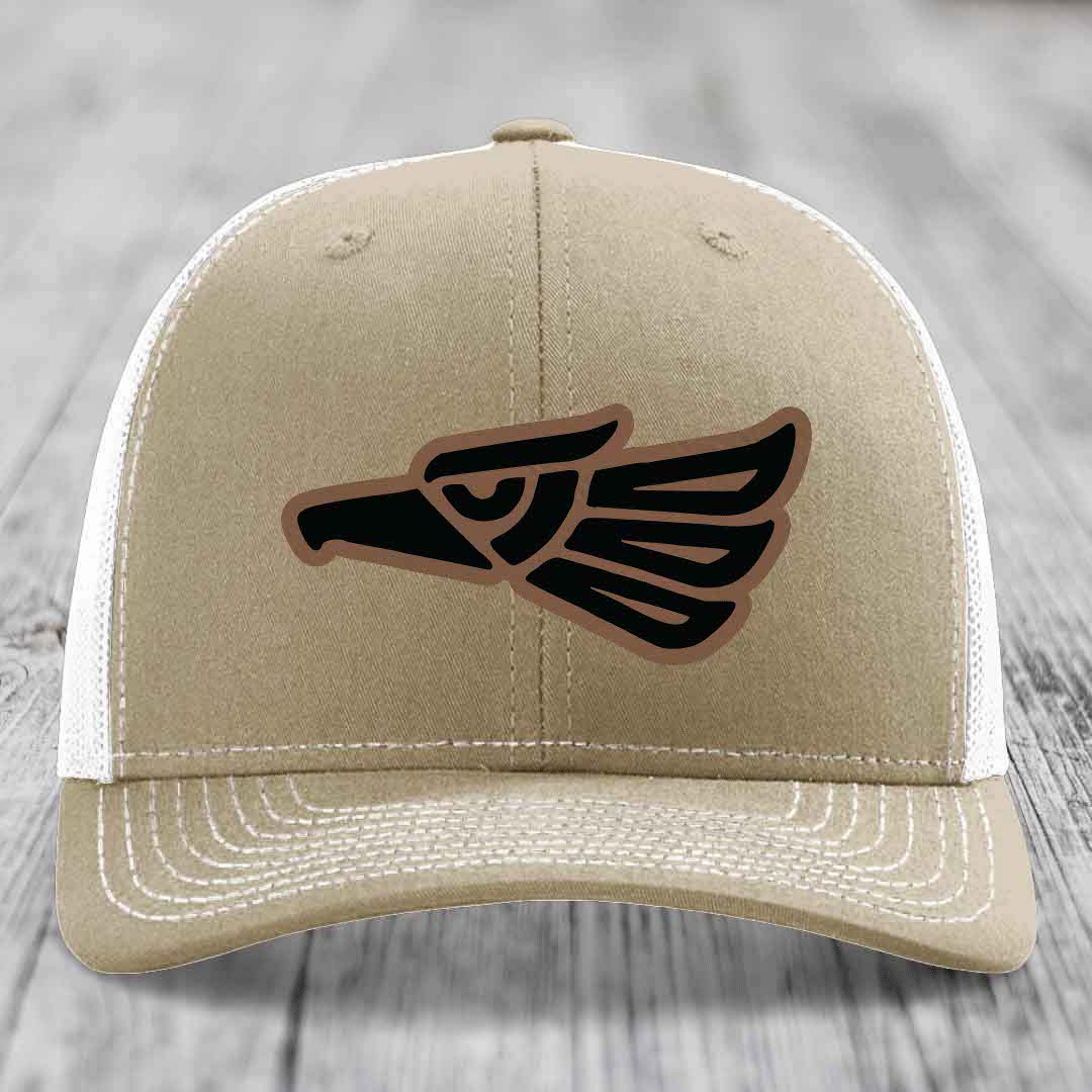 Tan trucker hat with black and brown Aztec eagle patch on front.