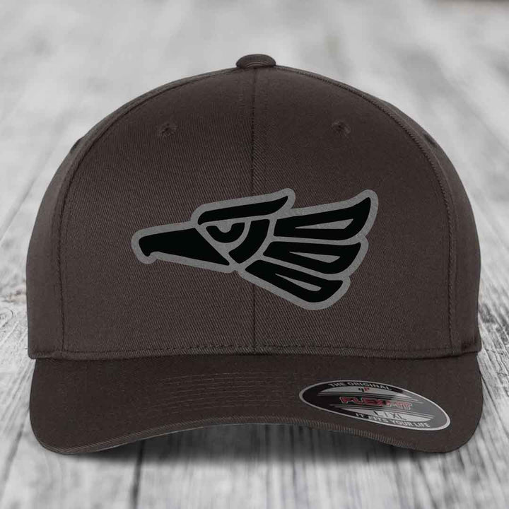Brown Flexfit hat with black and grey Aztec eagle patch on front.