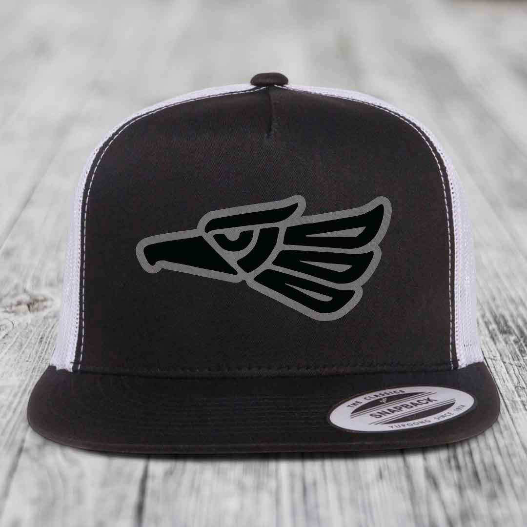 Black and white trucker hat with Aztec eagle patch on front.