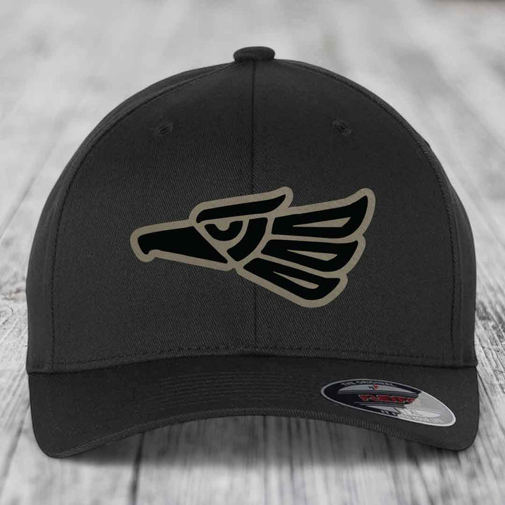 Black baseball cap with Aztec-style eagle patch on front, featuring black and tan design.