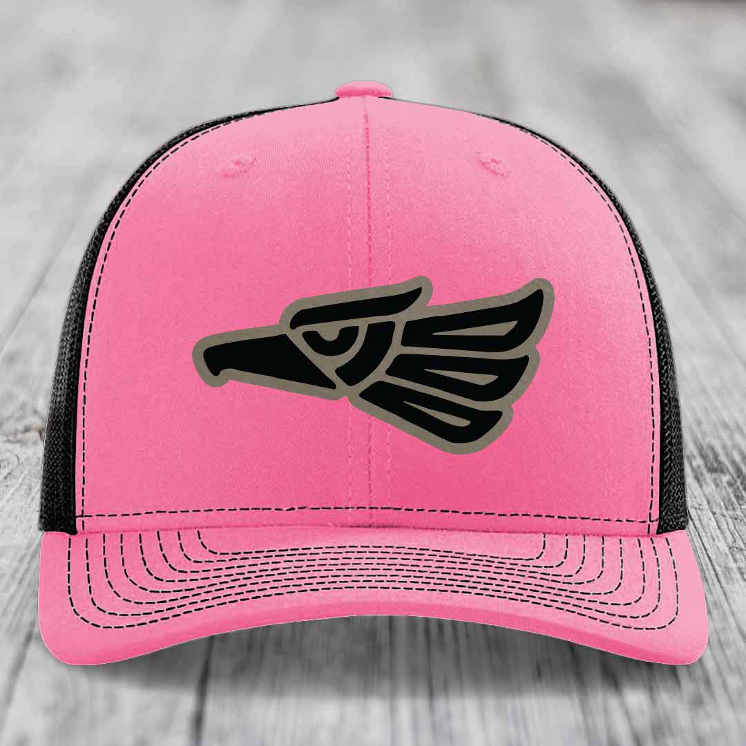 Pink trucker hat with black and grey Aztec eagle patch on front.