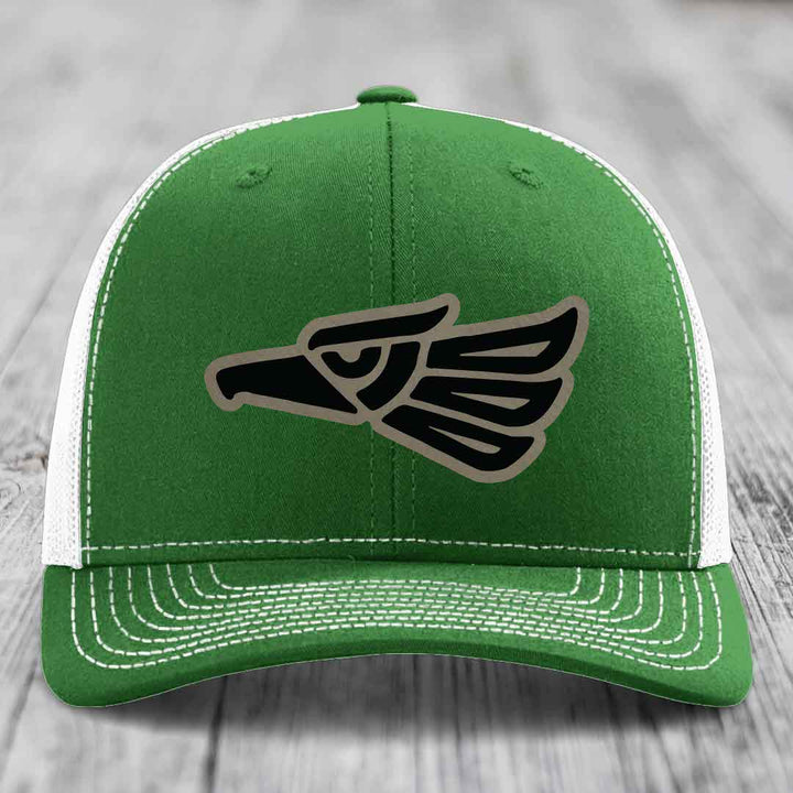 Green trucker hat with white mesh back and embroidered eagle patch on front.