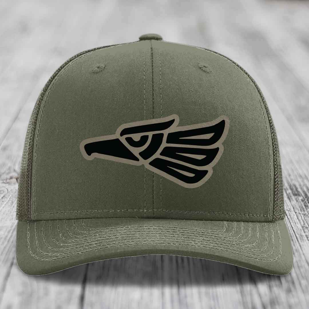 Olive green trucker hat with black and tan Aztec eagle patch on front.