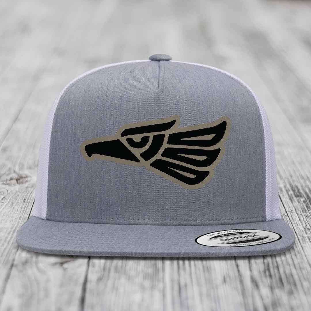 Grey trucker hat with black and tan Aztec eagle patch on front, white mesh back.