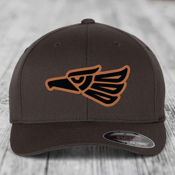 Brown Flexfit hat with Aztec-style eagle patch in black and tan leatherette.