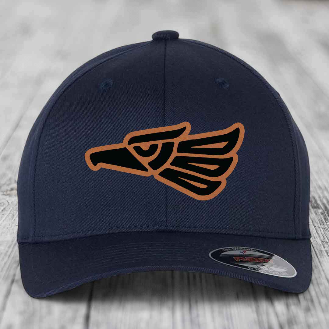 Dark blue baseball cap with embroidered Aztec-style eagle patch in black and tan.