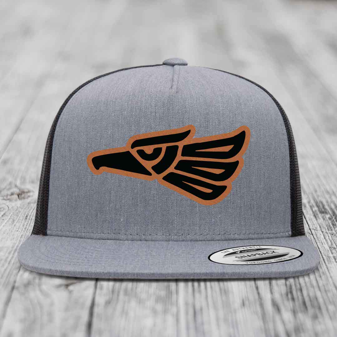 Grey trucker hat with black and tan Aztec eagle leather patch on front.