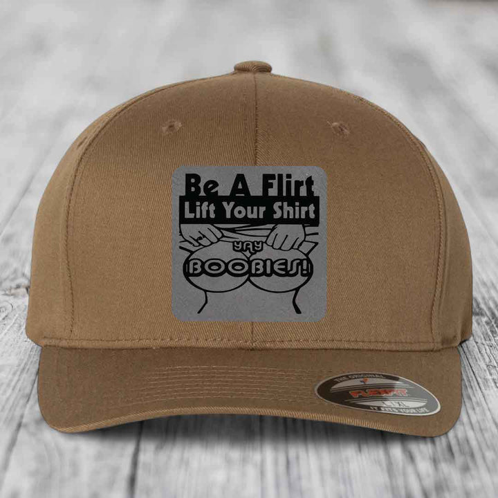 Tan baseball cap with black and gray patch reading &