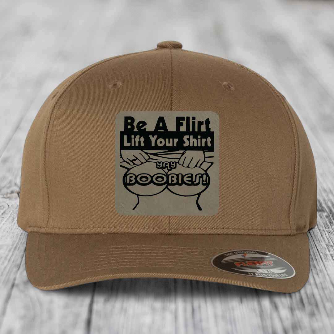 Tan baseball cap with black graphic patch reading &