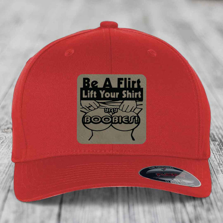 Red baseball cap with a square patch reading &
