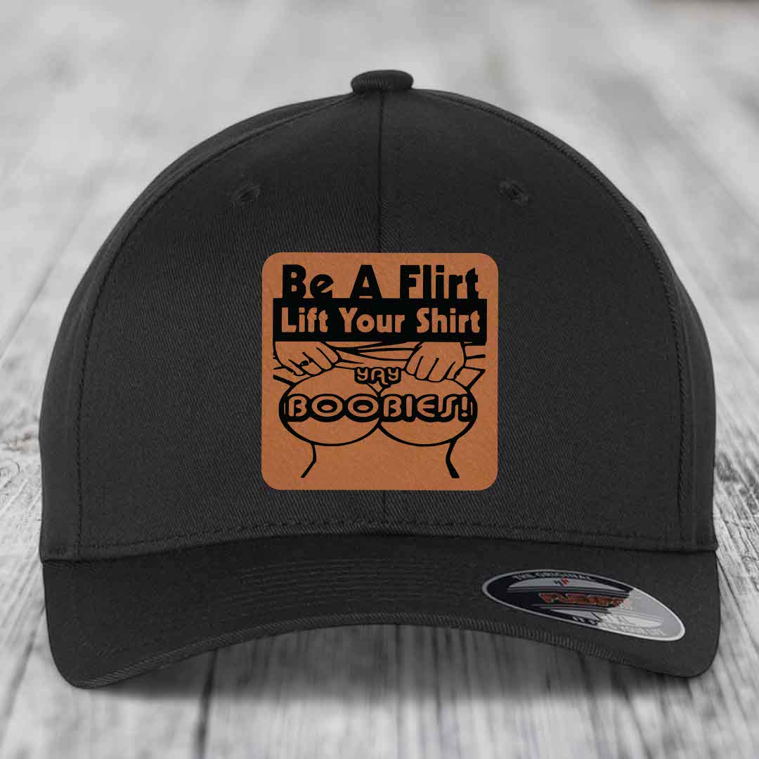 Black baseball cap with brown leatherette patch reading &
