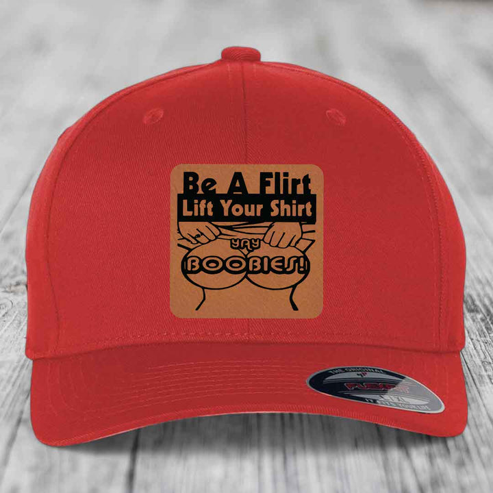 Red baseball cap with brown leatherette patch reading &