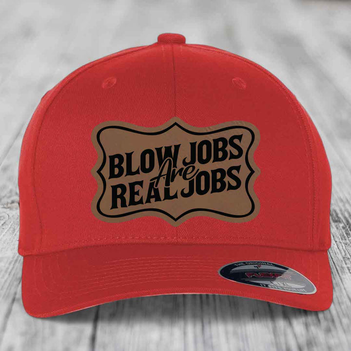 Red baseball cap with a brown leatherette patch that reads &