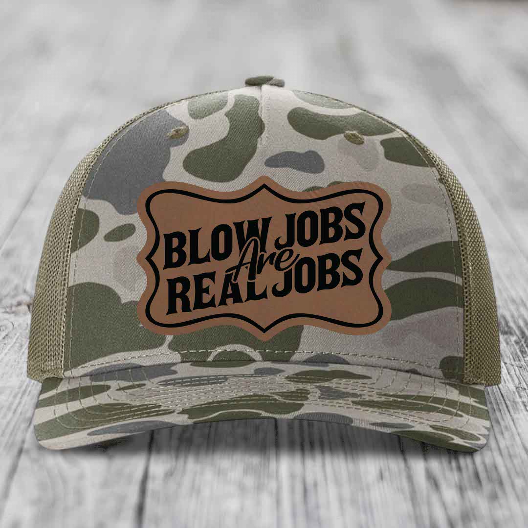 Camouflage trucker hat with brown leatherette patch reading &