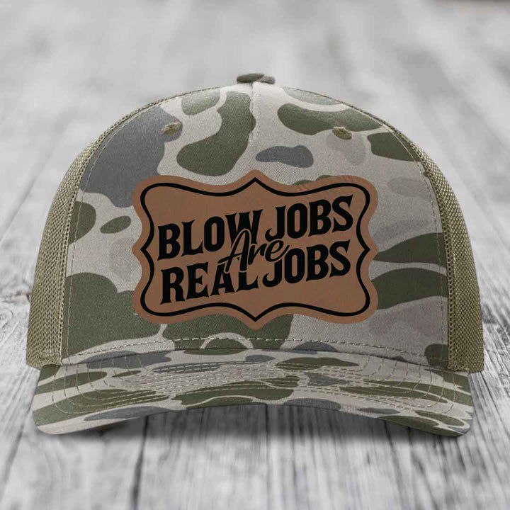Camouflage trucker hat with brown leatherette patch reading &