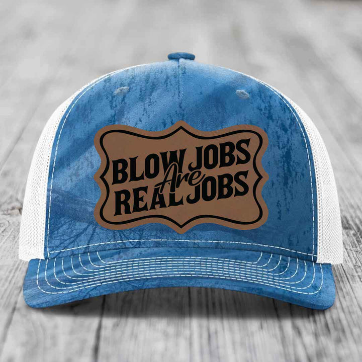 Blue and white trucker hat with a brown leatherette patch that reads &