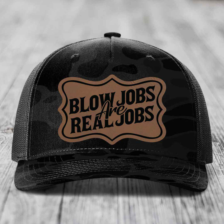 Black trucker hat with brown leatherette patch reading &