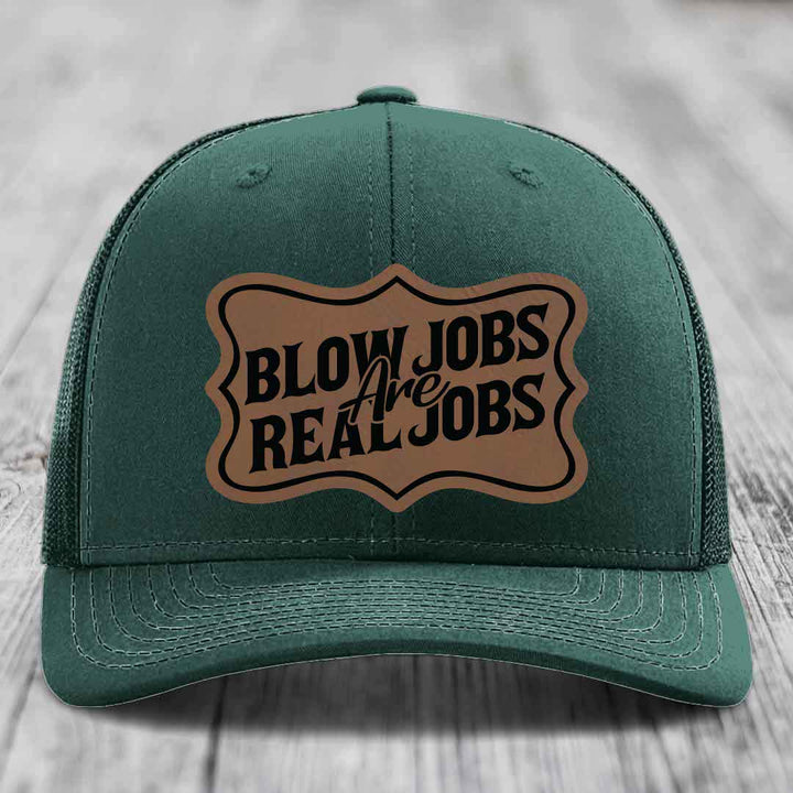 Green trucker hat with brown leatherette patch reading &