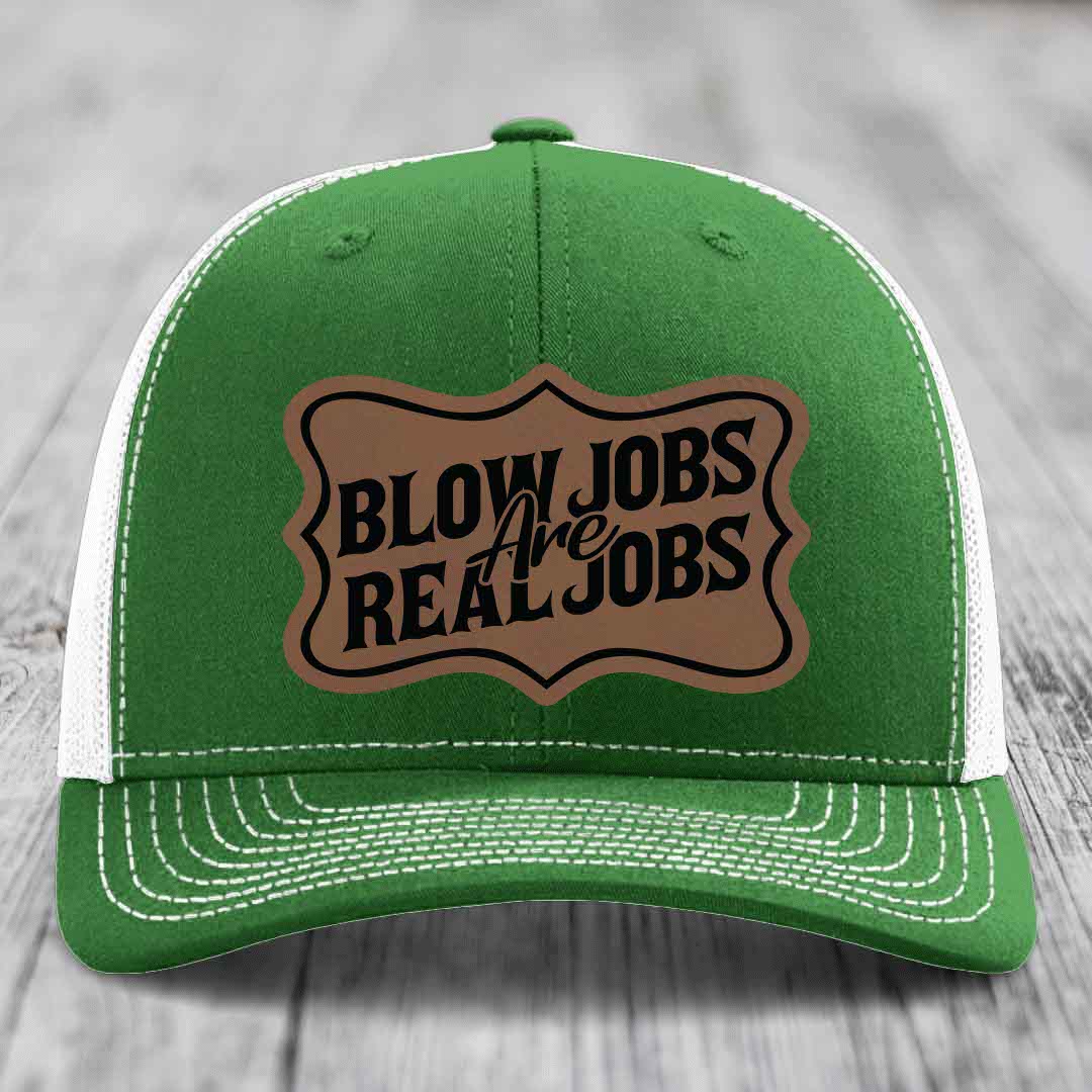 Green trucker hat with white mesh back and stitching, featuring a brown leatherette patch that reads &