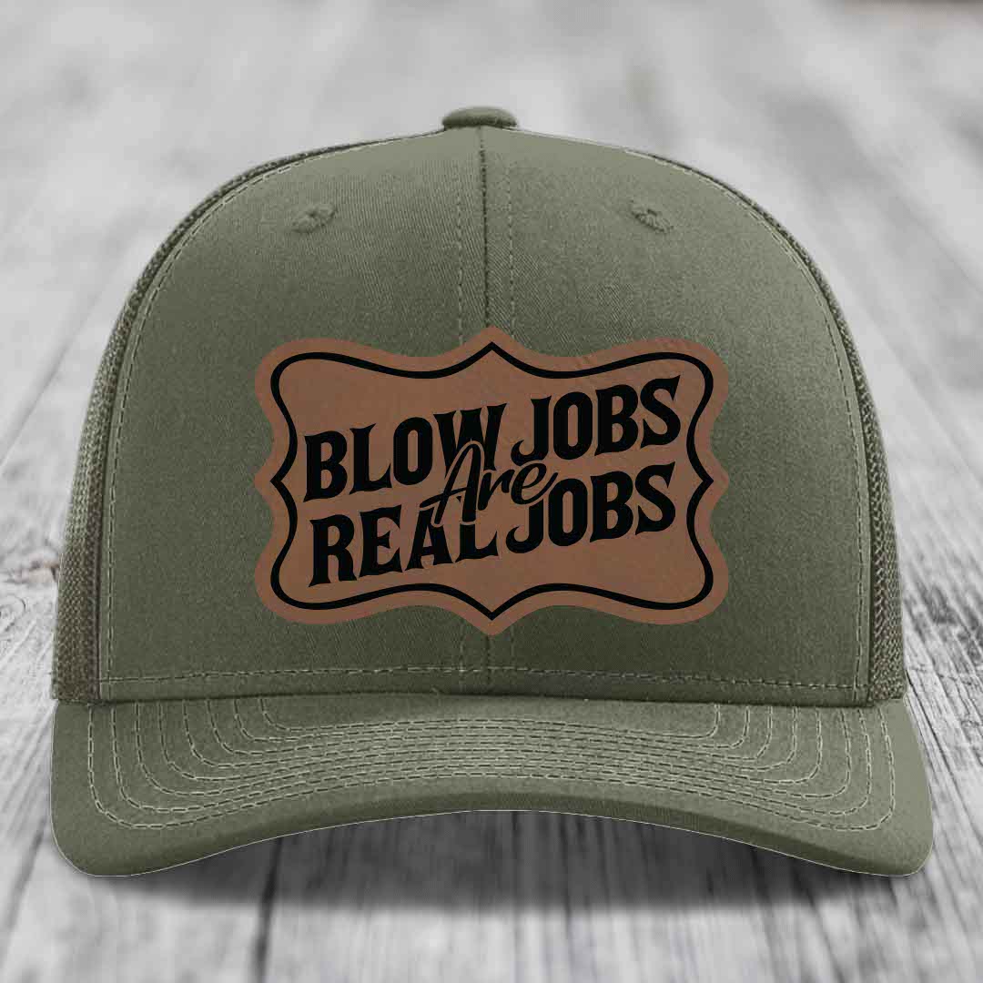 Olive green trucker hat with brown leather patch reading &