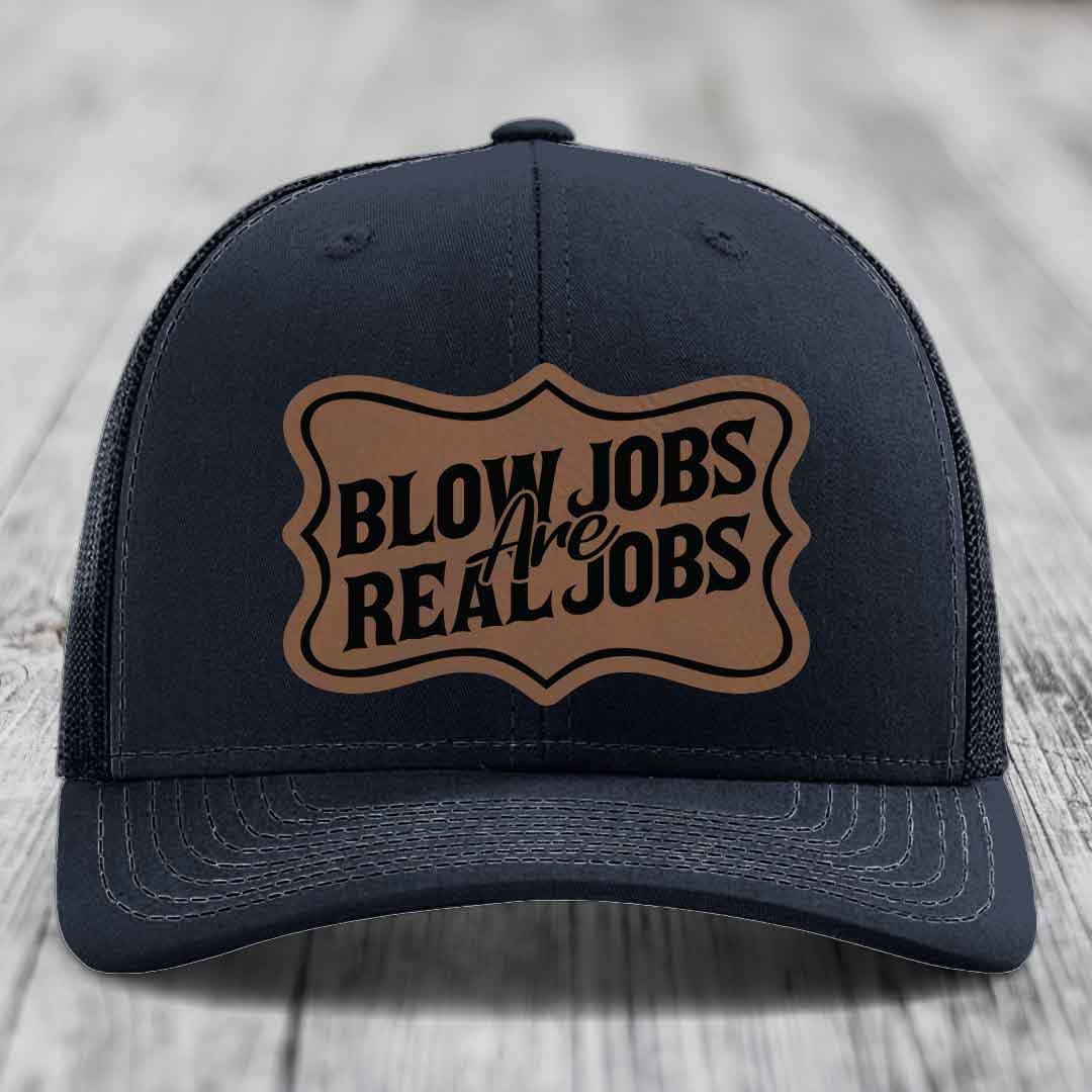 Dark blue trucker hat with brown leatherette patch reading &