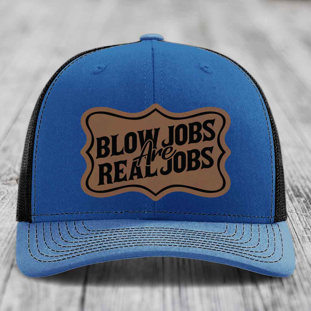 Blue trucker hat with brown leatherette patch reading &