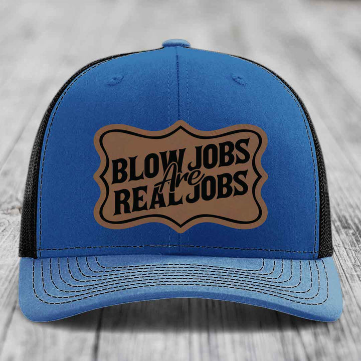 Blue trucker hat with brown leatherette patch reading &