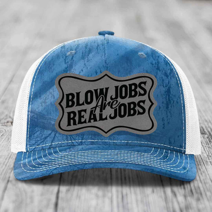 Blue and white trucker hat with a grey patch that reads &