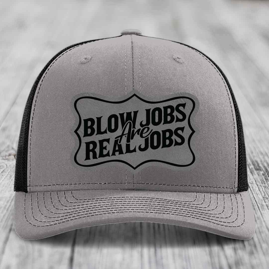 Grey trucker hat with black mesh back and embroidered &
