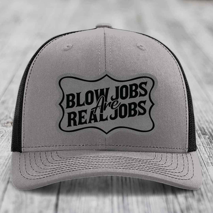 Grey trucker hat with black mesh back and embroidered &