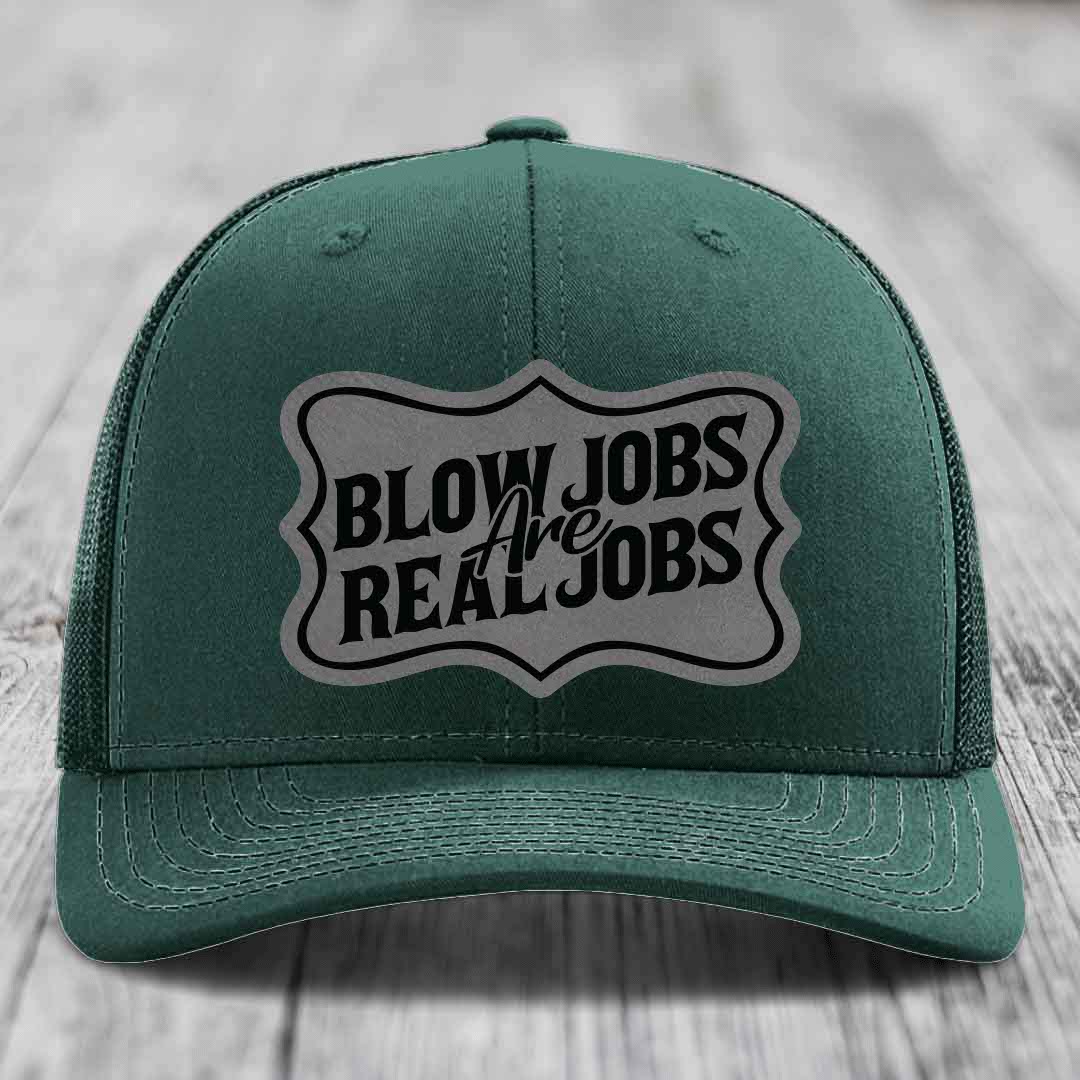 Green trucker hat with a grey shield patch that reads &