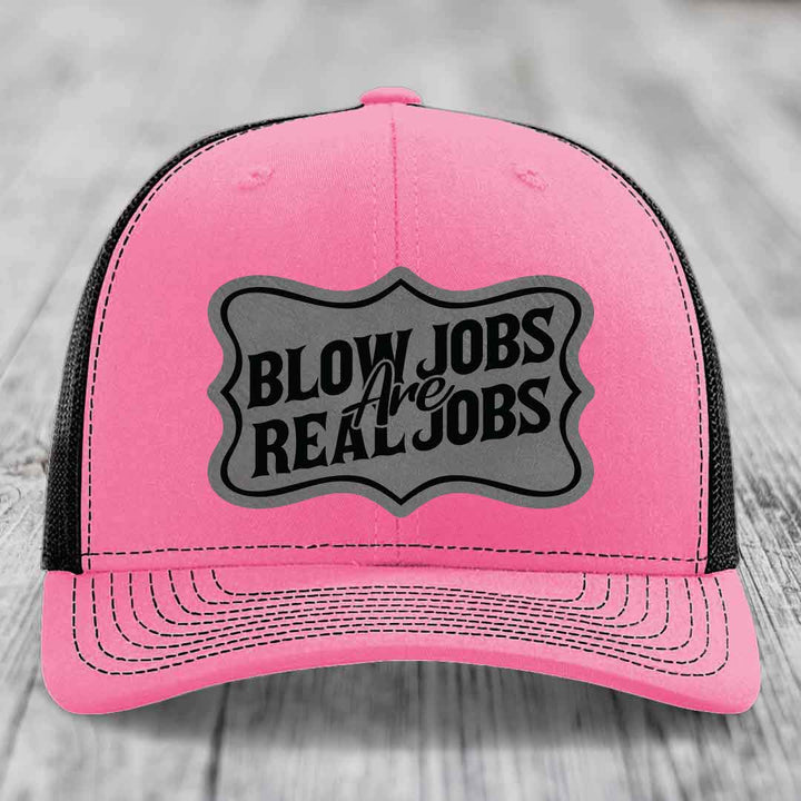 Pink trucker hat with black mesh back and gray patch reading &