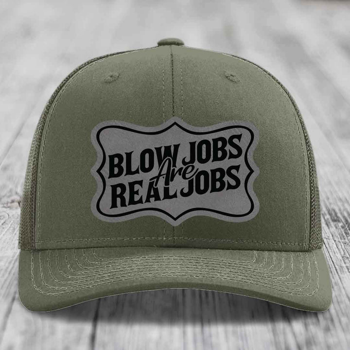 Olive green trucker hat with a grey patch that reads &
