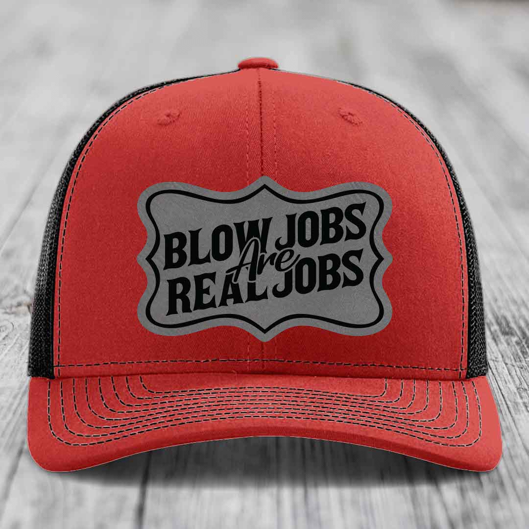 Red trucker hat with black mesh back and gray patch reading &