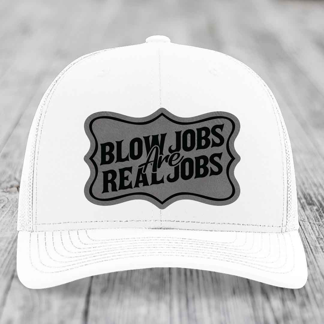 White trucker hat with black and grey patch reading &