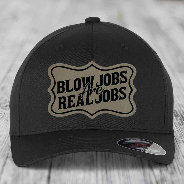 Black baseball cap with beige patch reading &