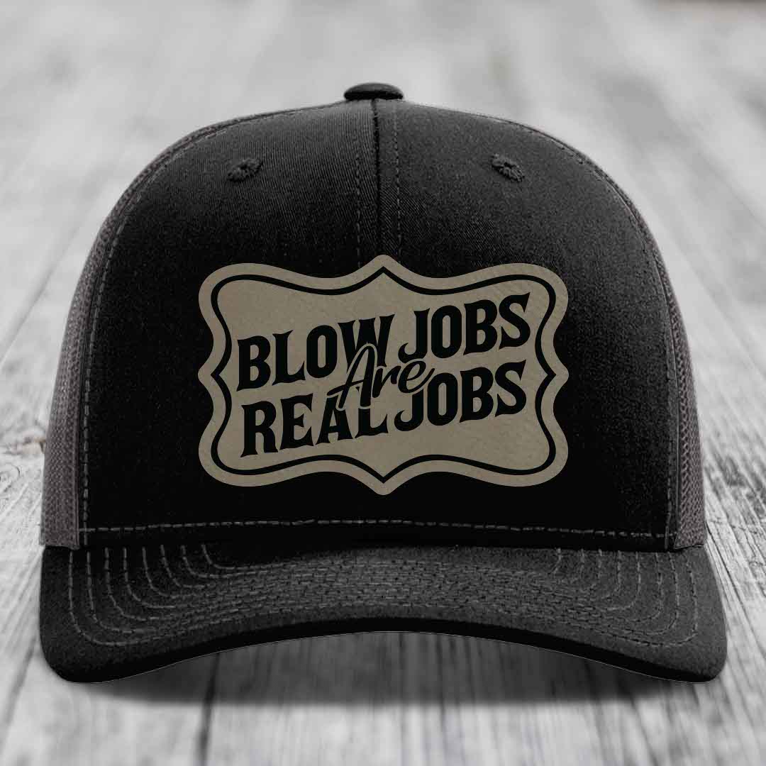 Black trucker hat with beige patch reading &