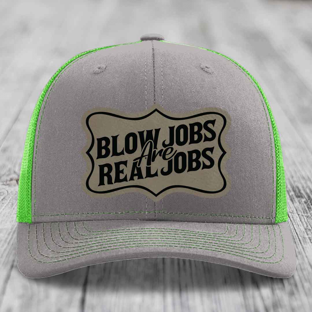 Grey trucker hat with neon green mesh and stitching, featuring a beige patch that reads &