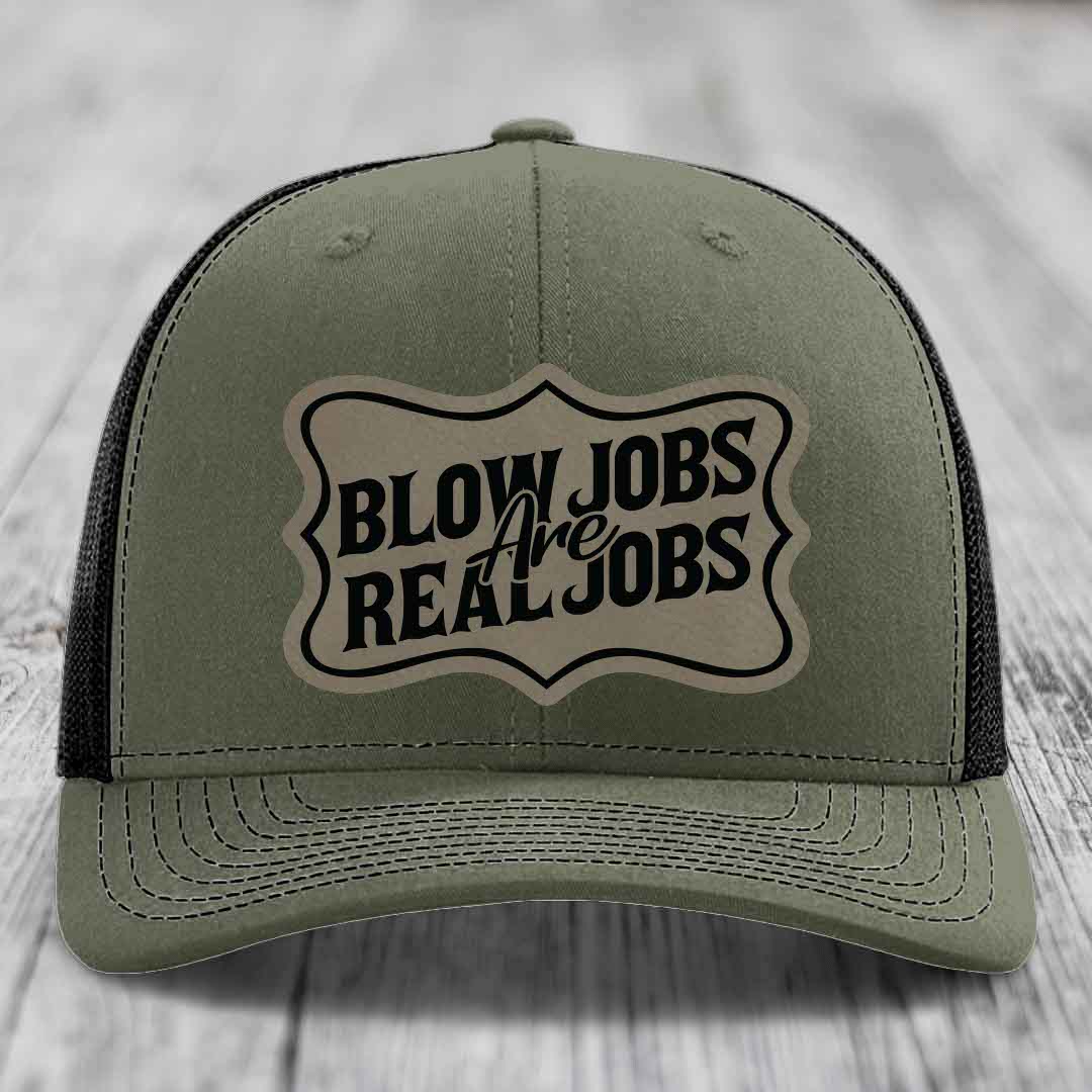 Olive green trucker hat with black mesh back and a beige leatherette patch reading &