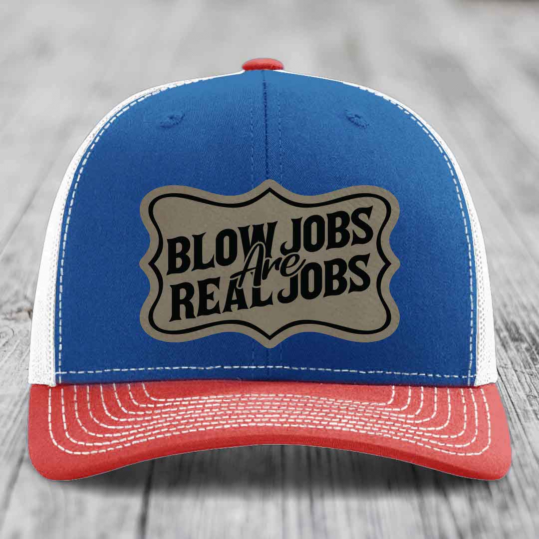 Blue and red trucker hat with a beige leatherette patch that reads &