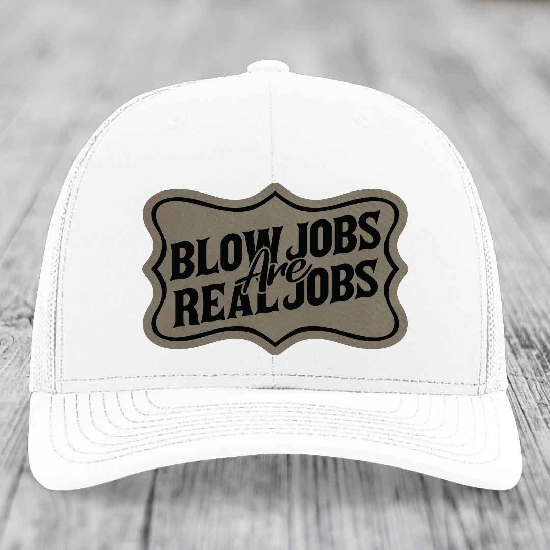 White trucker hat with a brown leatherette patch that reads &