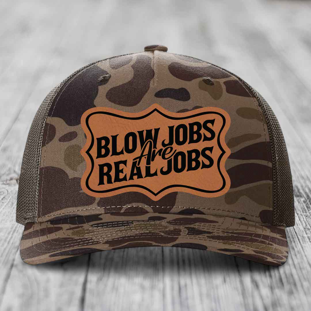 Camouflage trucker hat with brown leatherette patch reading &