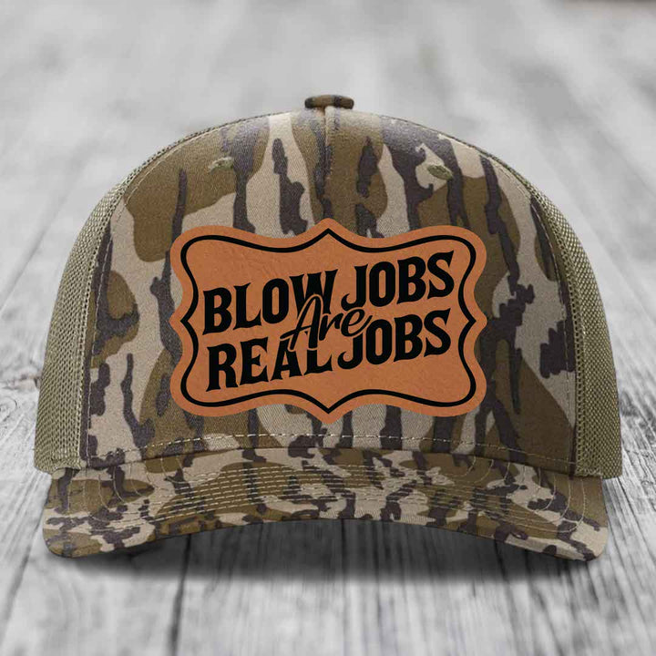 Camouflage trucker hat with brown leatherette patch reading &