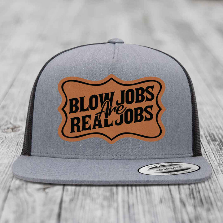 Grey trucker hat with brown leatherette patch reading &